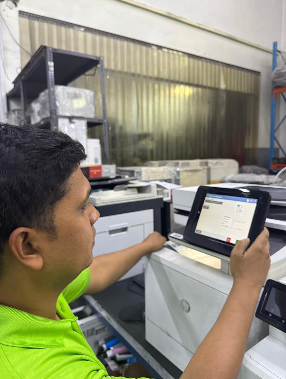 GIT technician inspecting an HP printer at the Dubai remanufacturing facility